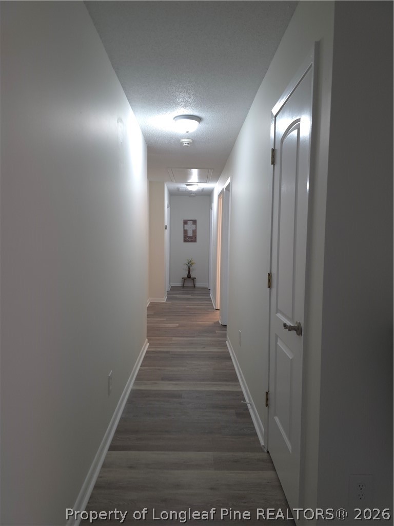 5945 Muscat Road Hope Mills, NC 28348 - Photo 15 of 36 a view of a hallway with wooden floor