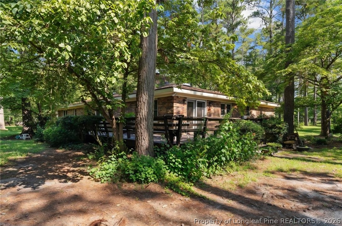 5945 Muscat Road Hope Mills, NC 28348 - Photo 26 of 36 a view of a house with garden and trees