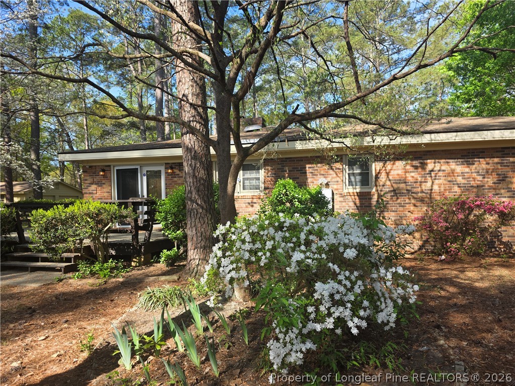 5945 Muscat Road Hope Mills, NC 28348 - Photo 31 of 36 a yellow house with flower in front of it
