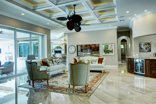 a kitchen with granite countertop a table chairs sink and cabinets