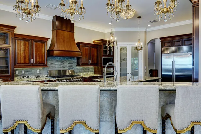 a bathroom with a granite countertop sink a large window and a wooden floor
