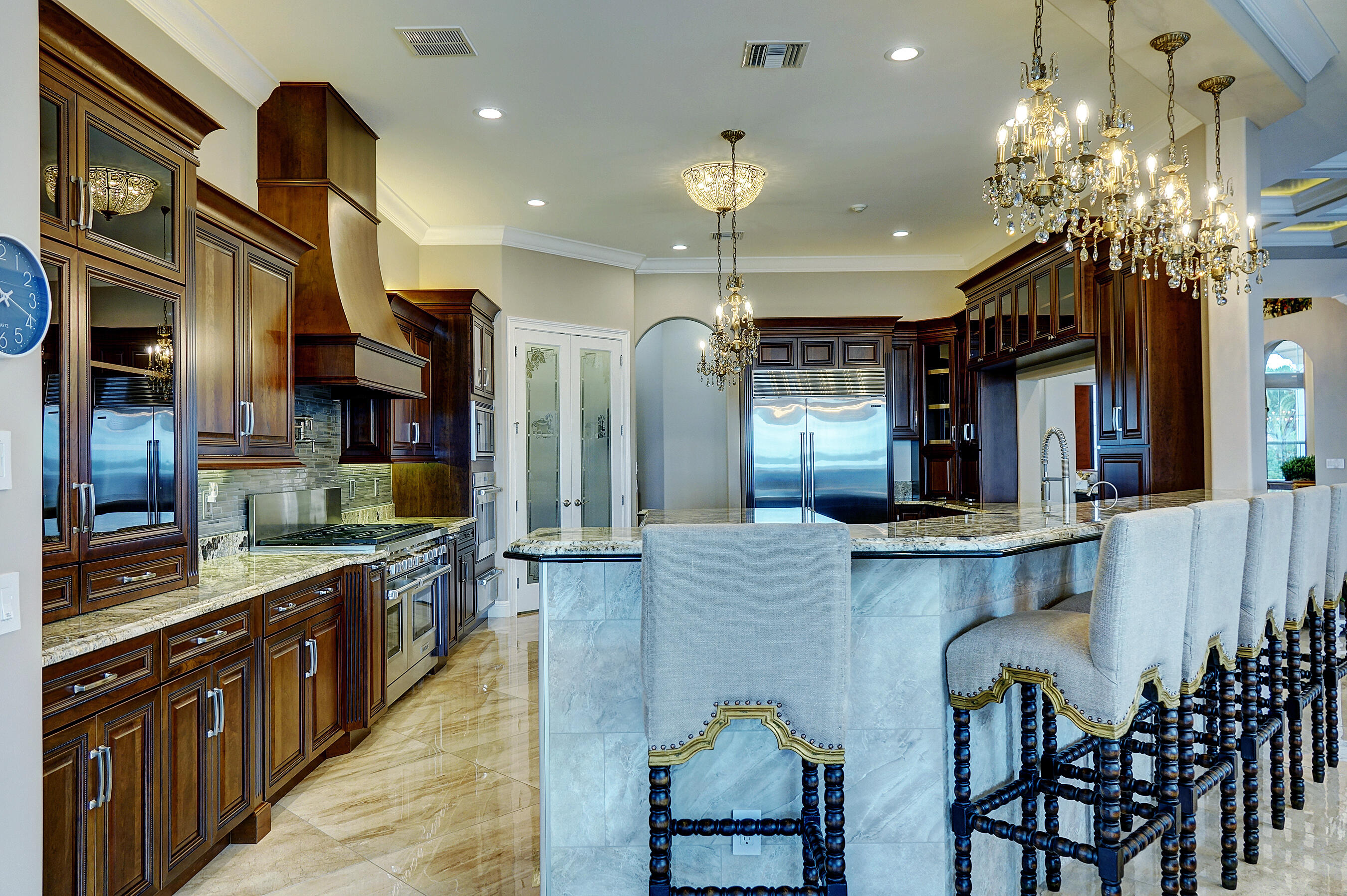 2690 Northwest Collins Cove Road Stuart, FL 34994 - Photo 20 of 78 a kitchen with granite countertop a table chairs sink and cabinets