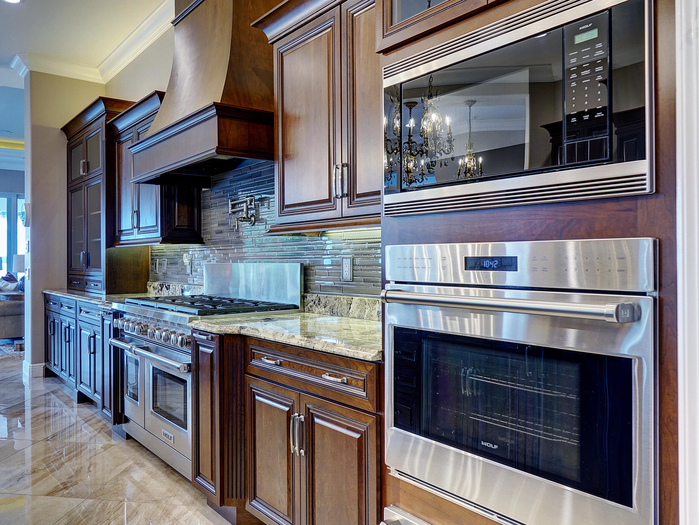 2690 Northwest Collins Cove Road Stuart, FL 34994 - Photo 23 of 78 a kitchen with stainless steel appliances granite countertop a stove and a microwave