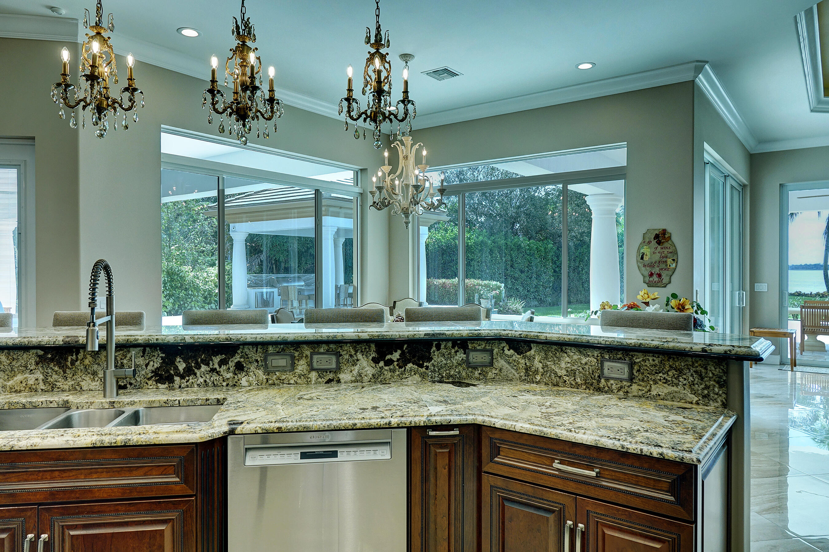 2690 Northwest Collins Cove Road Stuart, FL 34994 - Photo 26 of 78 a bathroom with a granite countertop sink a large window and a wooden floor