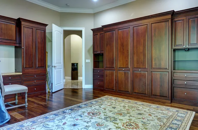 a front view of a house with a yard and potted plants