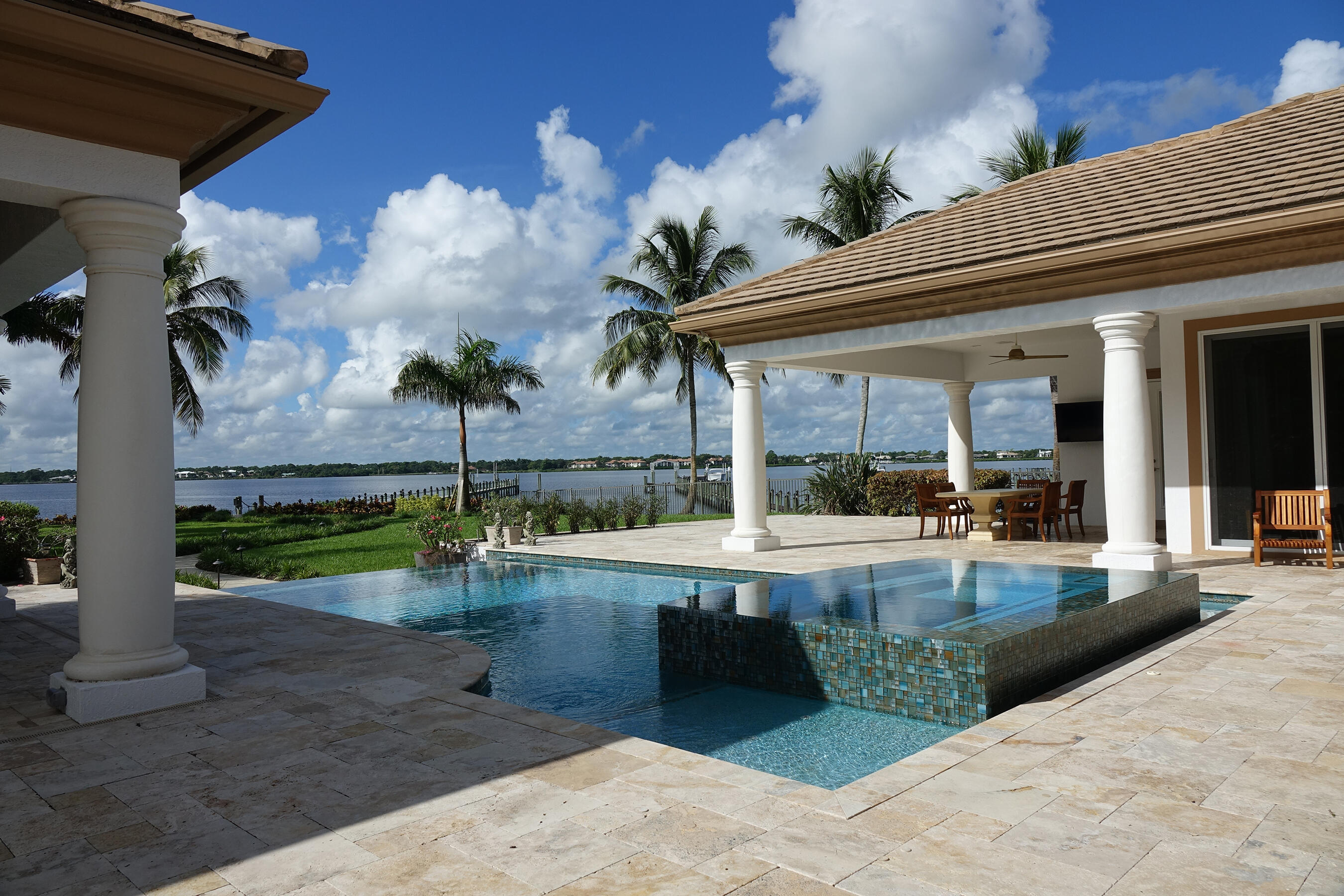2690 Northwest Collins Cove Road Stuart, FL 34994 - Photo 48 of 78 a view of a swimming pool with a patio