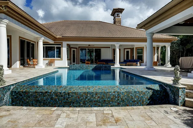 a backyard of a house with lots of green space and lake view