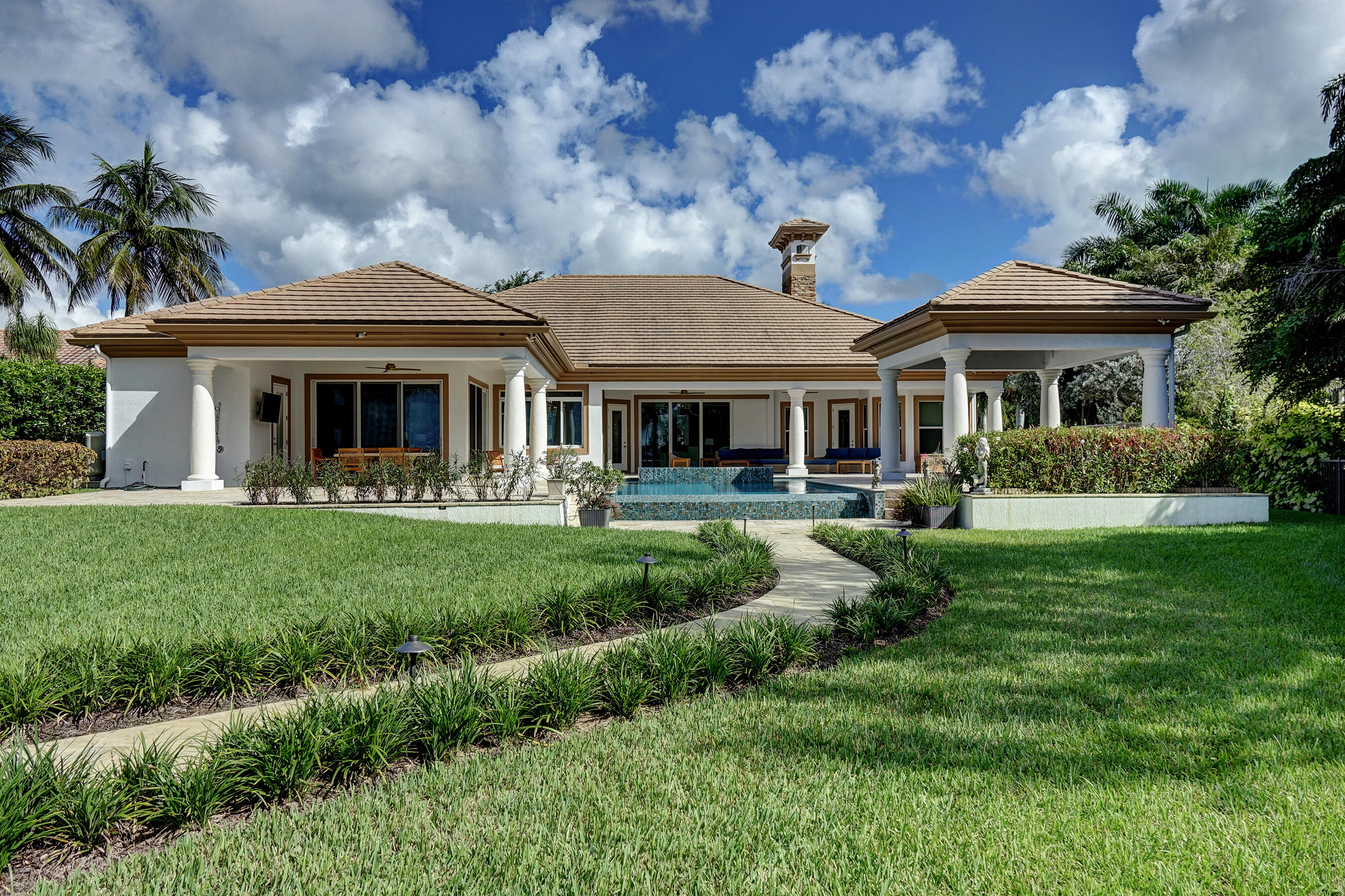 2690 Northwest Collins Cove Road Stuart, FL 34994 - Photo 5 of 78 a front view of a house with yard and green space