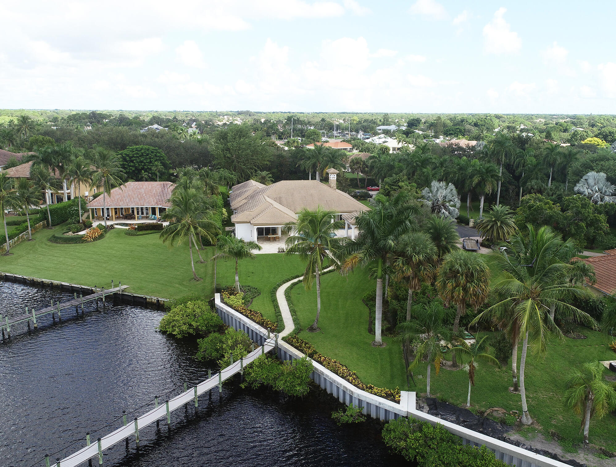 2690 Northwest Collins Cove Road Stuart, FL 34994 - Photo 57 of 78 an aerial view of a house with a garden and lake view