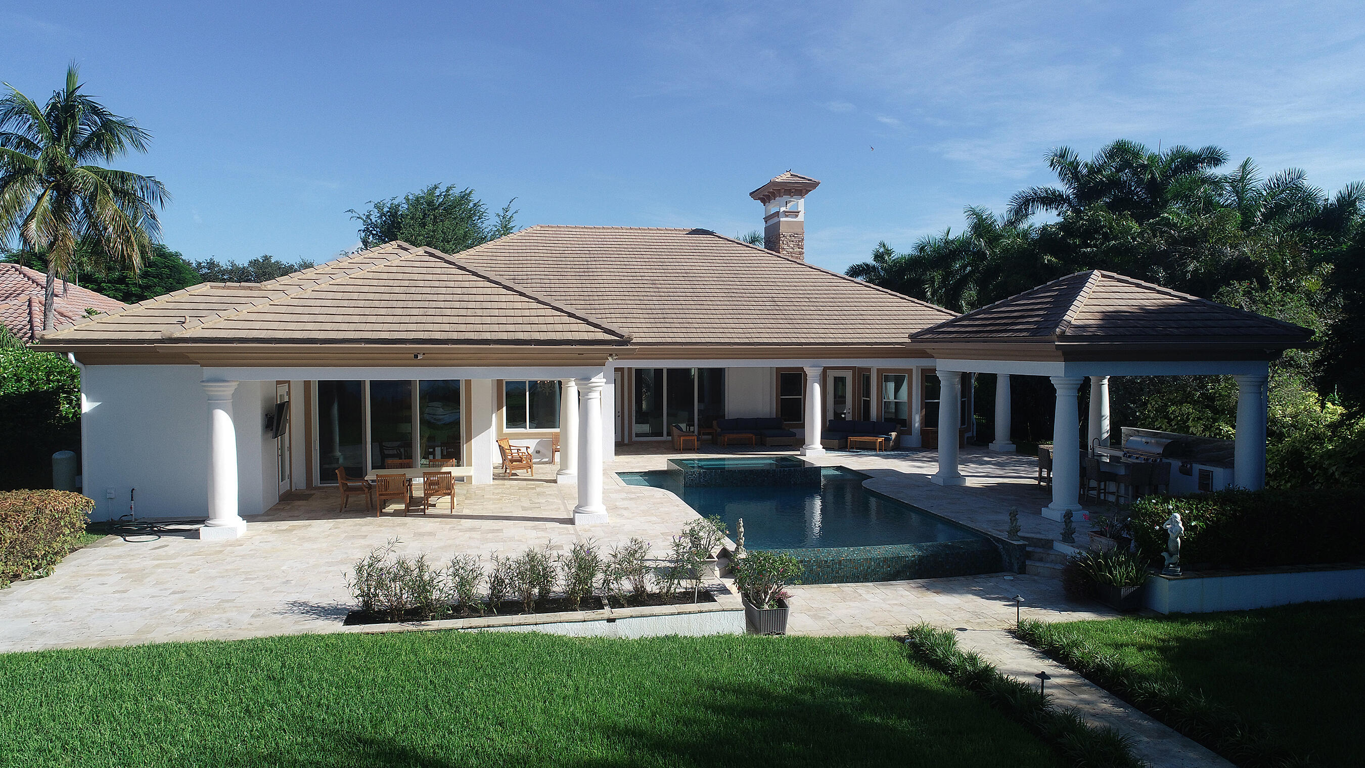 2690 Northwest Collins Cove Road Stuart, FL 34994 - Photo 66 of 78 a view of a house with swimming pool and a yard