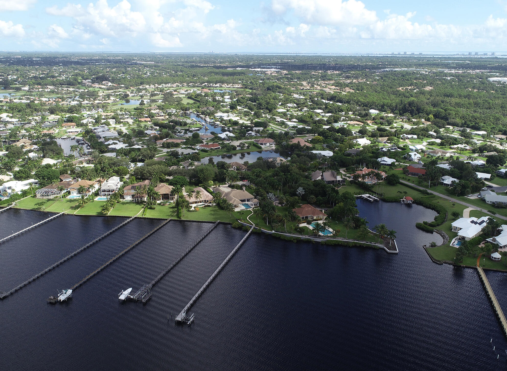 2690 Northwest Collins Cove Road Stuart, FL 34994 - Photo 74 of 78 an aerial view of residential houses with outdoor space and trees