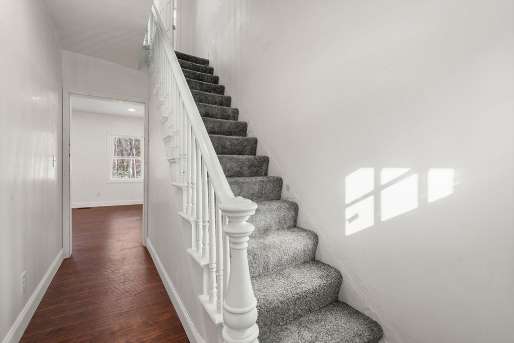 99 Main Street, Unit A Upton, MA 01568 - Photo 11 of 21 a view of entryway and hall with wooden floor