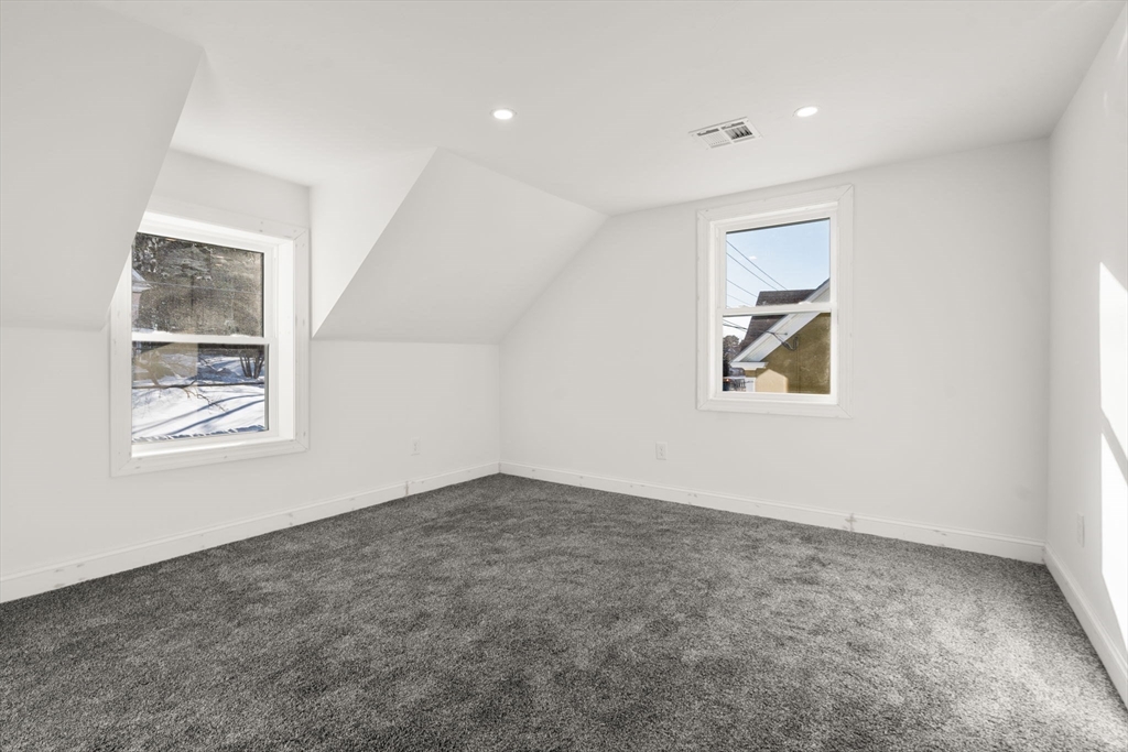 99 Main Street, Unit A Upton, MA 01568 - Photo 13 of 21 an empty room with windows