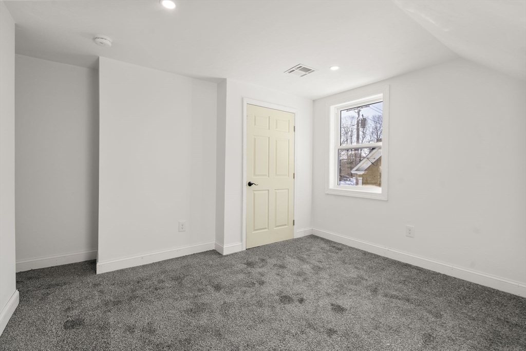 99 Main Street, Unit A Upton, MA 01568 - Photo 14 of 21 an empty room with windows