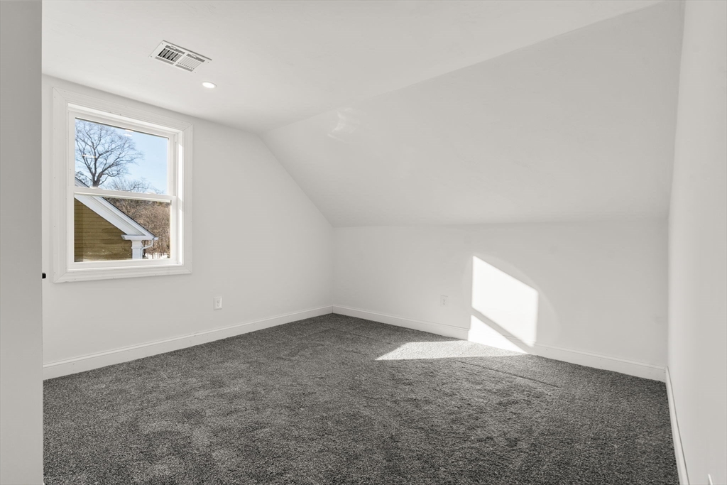 99 Main Street, Unit A Upton, MA 01568 - Photo 15 of 21 an empty room with windows