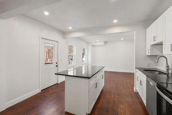 an empty room with a window and closet
