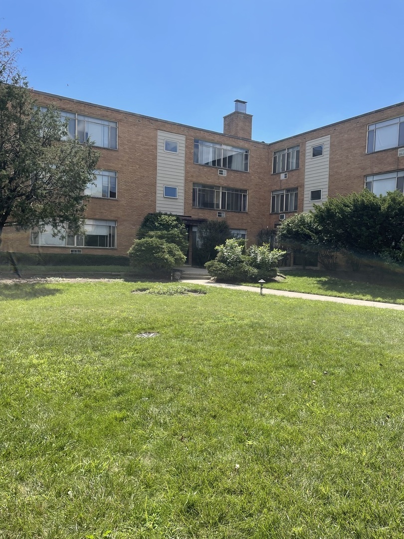 a view of a house with a yard and swimming pool