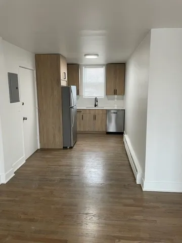 a view of kitchen with stainless steel appliances refrigerator and microwave