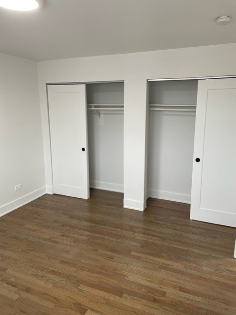 7529 North Maplewood Avenue, Unit 7B Chicago, IL 60645 - Photo 4 of 10 a view of an empty room with wooden floor and closet