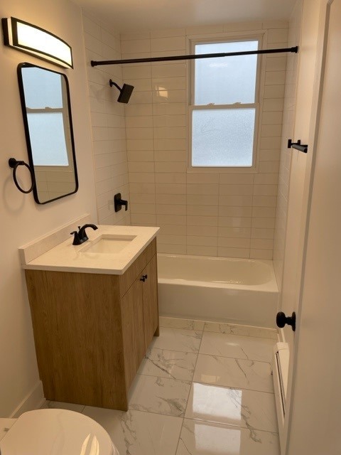 7529 North Maplewood Avenue, Unit 7B Chicago, IL 60645 - Photo 9 of 10 a bathroom with a sink toilet and shower