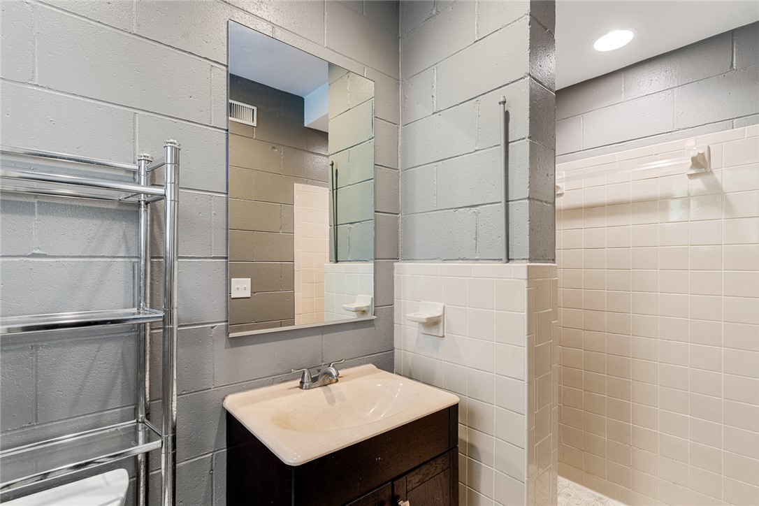 512 East Fredericks Street Anderson, SC 29621 - Photo 24 of 31 Functional bathroom in the basement featuring a vanity with an integrated sink and an adjacent shower stall.