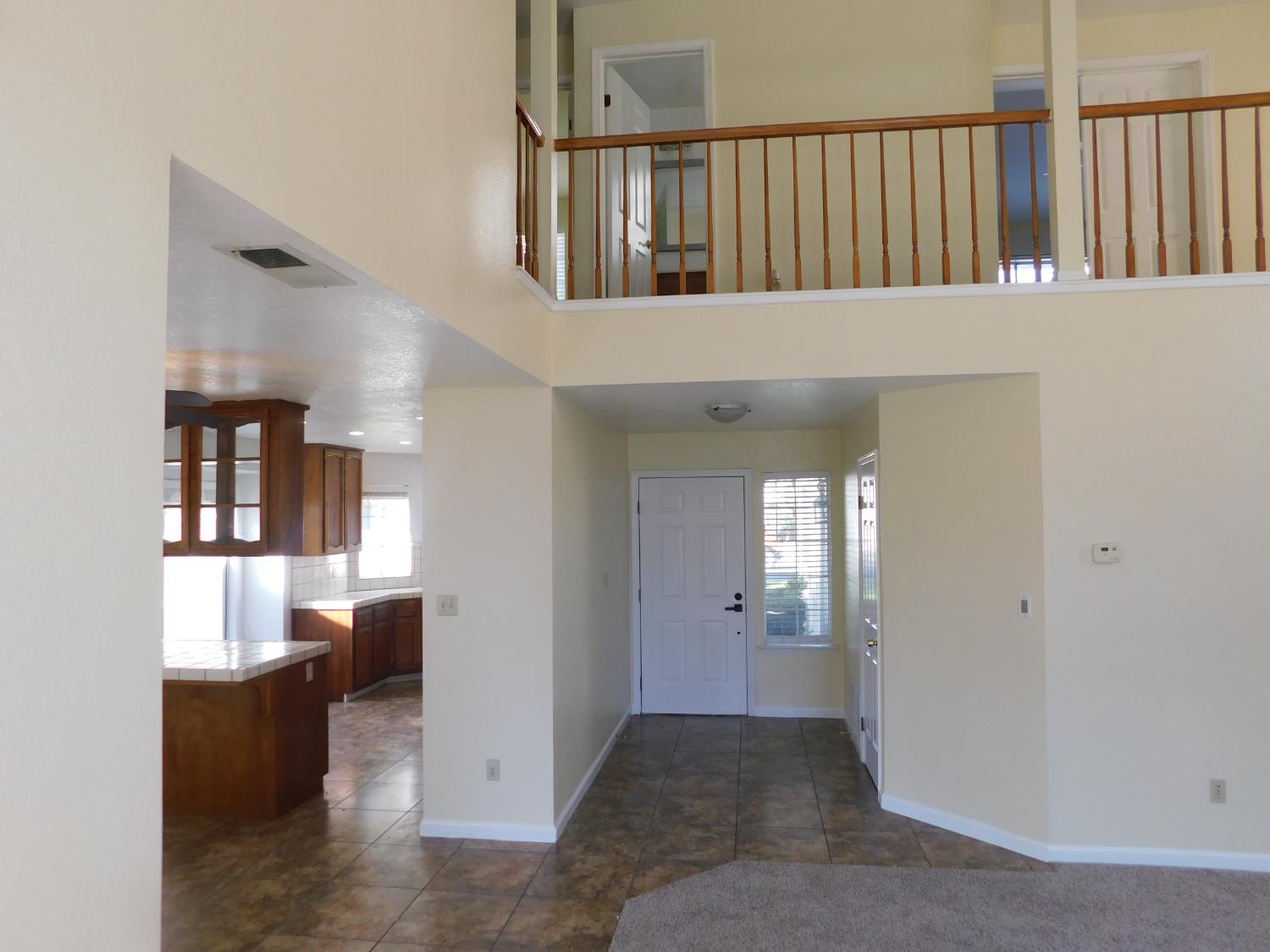 2316 Mountain Quail Way Modesto, CA 95355 - Photo 13 of 49 a view of entryway and hall with wooden floor