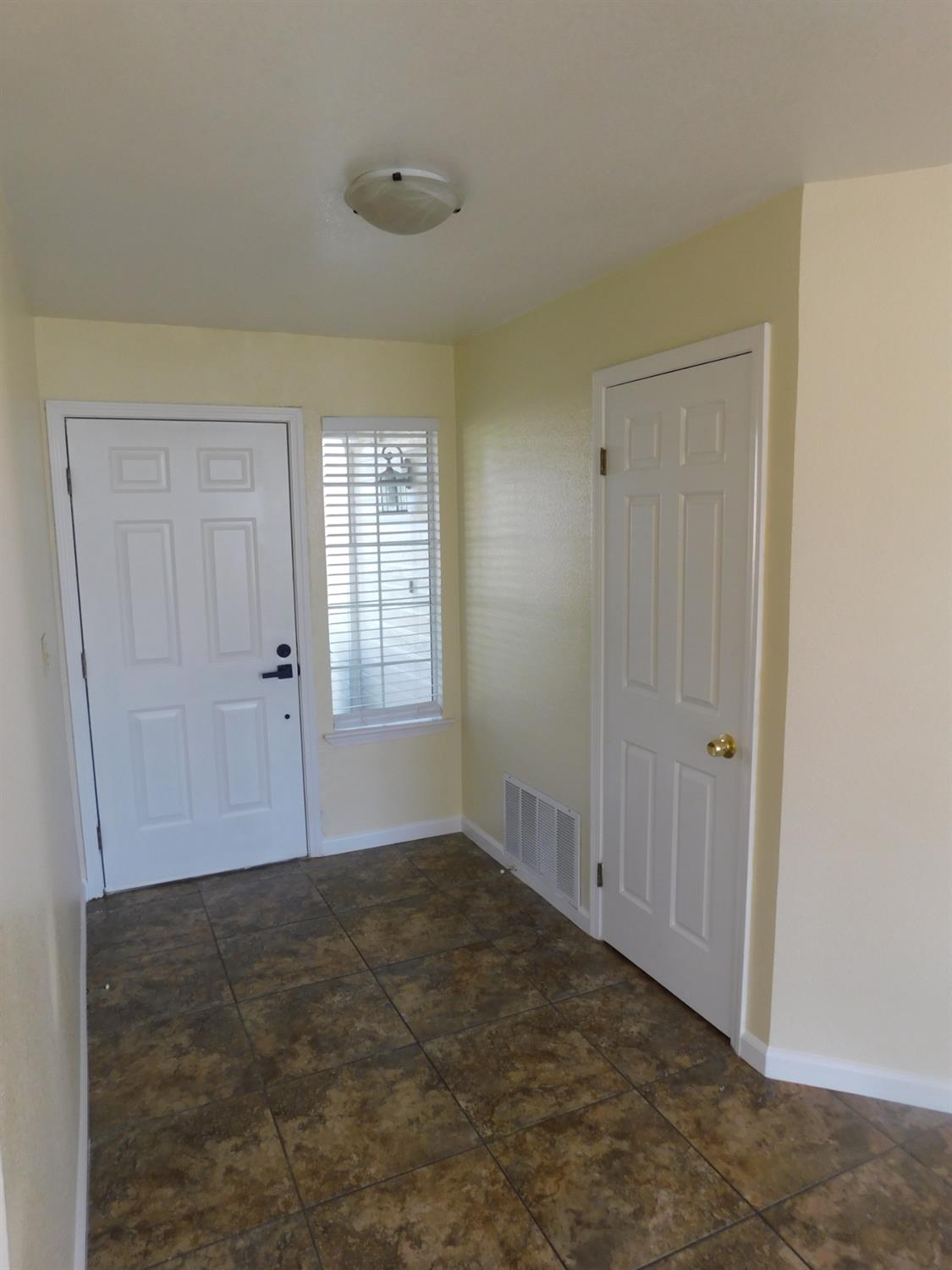 2316 Mountain Quail Way Modesto, CA 95355 - Photo 14 of 49 a view of an empty room with window and closet area