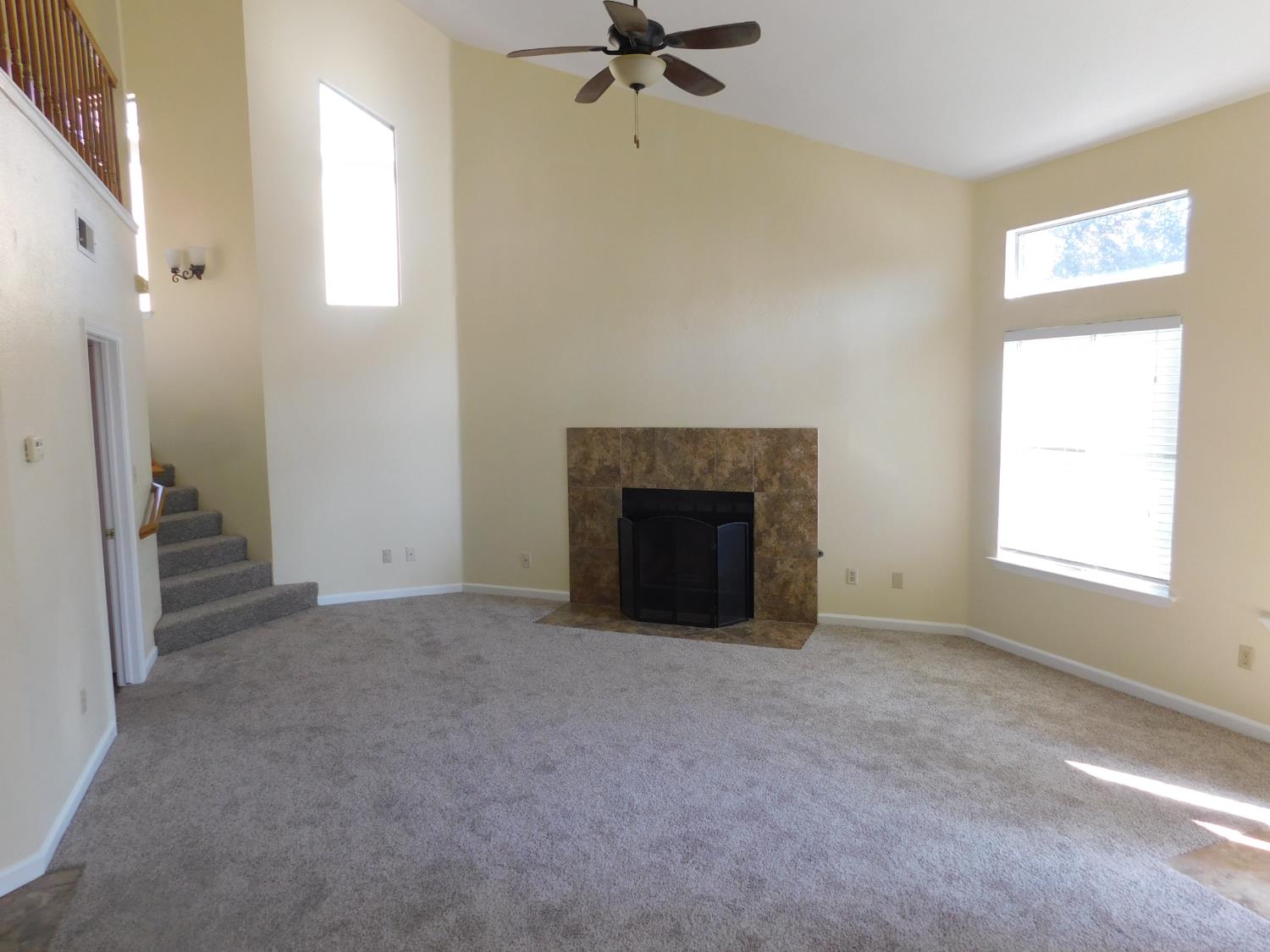2316 Mountain Quail Way Modesto, CA 95355 - Photo 17 of 49 an empty room with windows and a fireplace