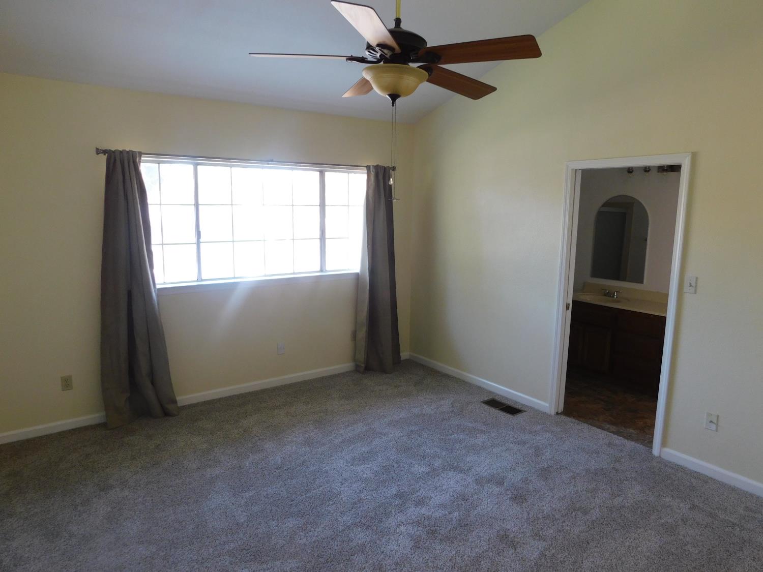 2316 Mountain Quail Way Modesto, CA 95355 - Photo 22 of 49 an empty room with windows and fan