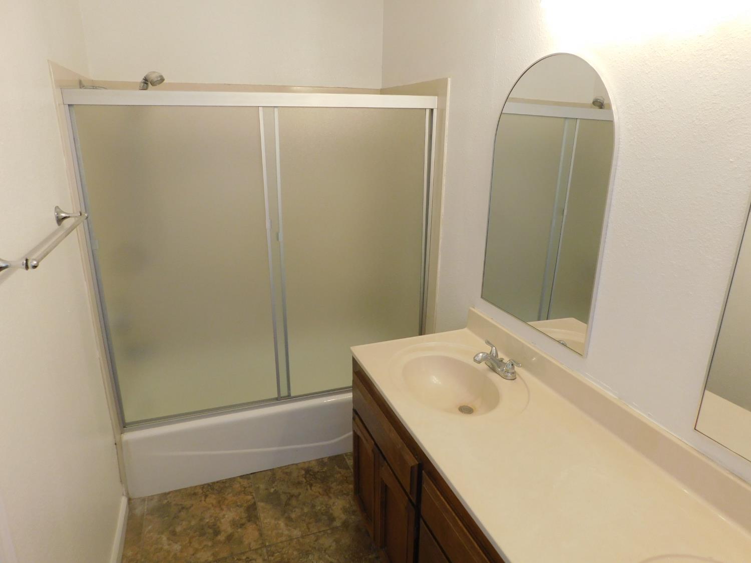 2316 Mountain Quail Way Modesto, CA 95355 - Photo 23 of 49 a bathroom with a granite countertop sink and a mirror
