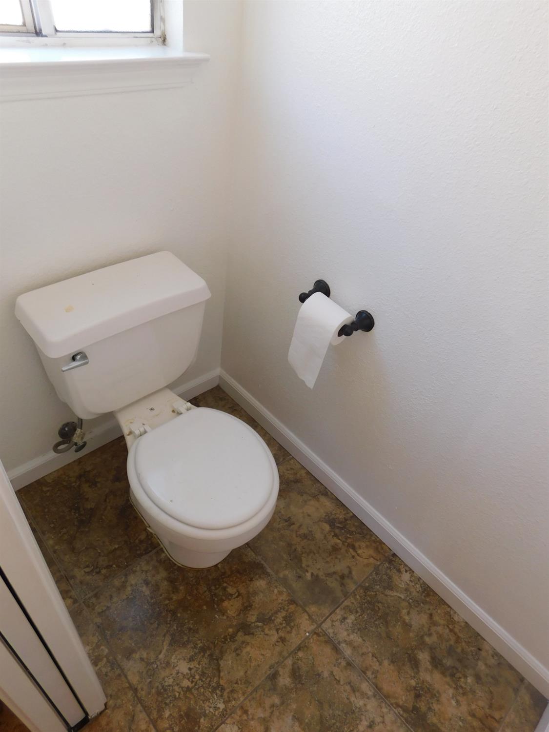 2316 Mountain Quail Way Modesto, CA 95355 - Photo 26 of 49 a bathroom with a toilet