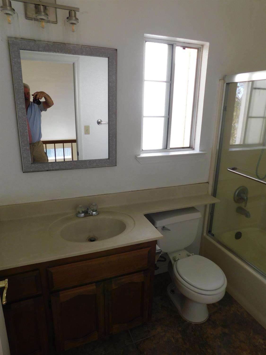 2316 Mountain Quail Way Modesto, CA 95355 - Photo 29 of 49 a bathroom with a toilet a sink and mirror