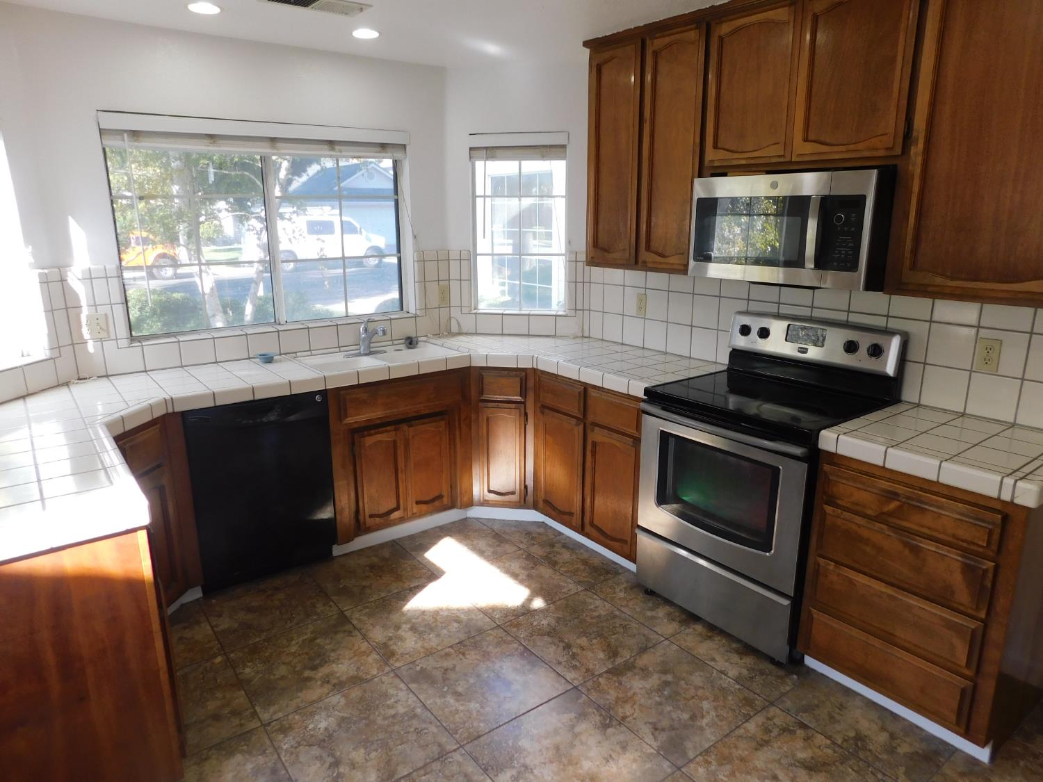 2316 Mountain Quail Way Modesto, CA 95355 - Photo 8 of 49 a kitchen with a sink stove and microwave