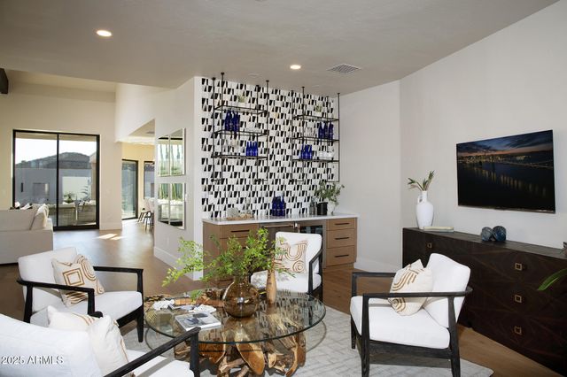 a living room with furniture potted plant and a flat screen tv