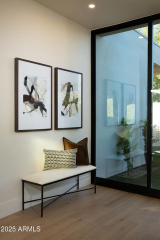 a living room with furniture and a painting on the wall