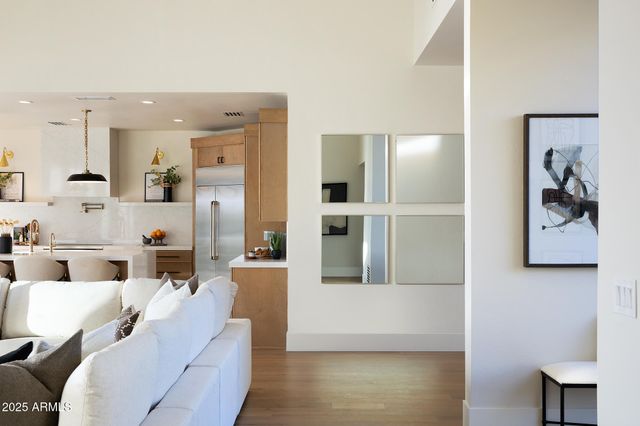 a living room with furniture and a painting on the wall