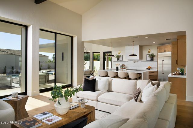 a kitchen with stainless steel appliances granite countertop a sink a stove and a refrigerator