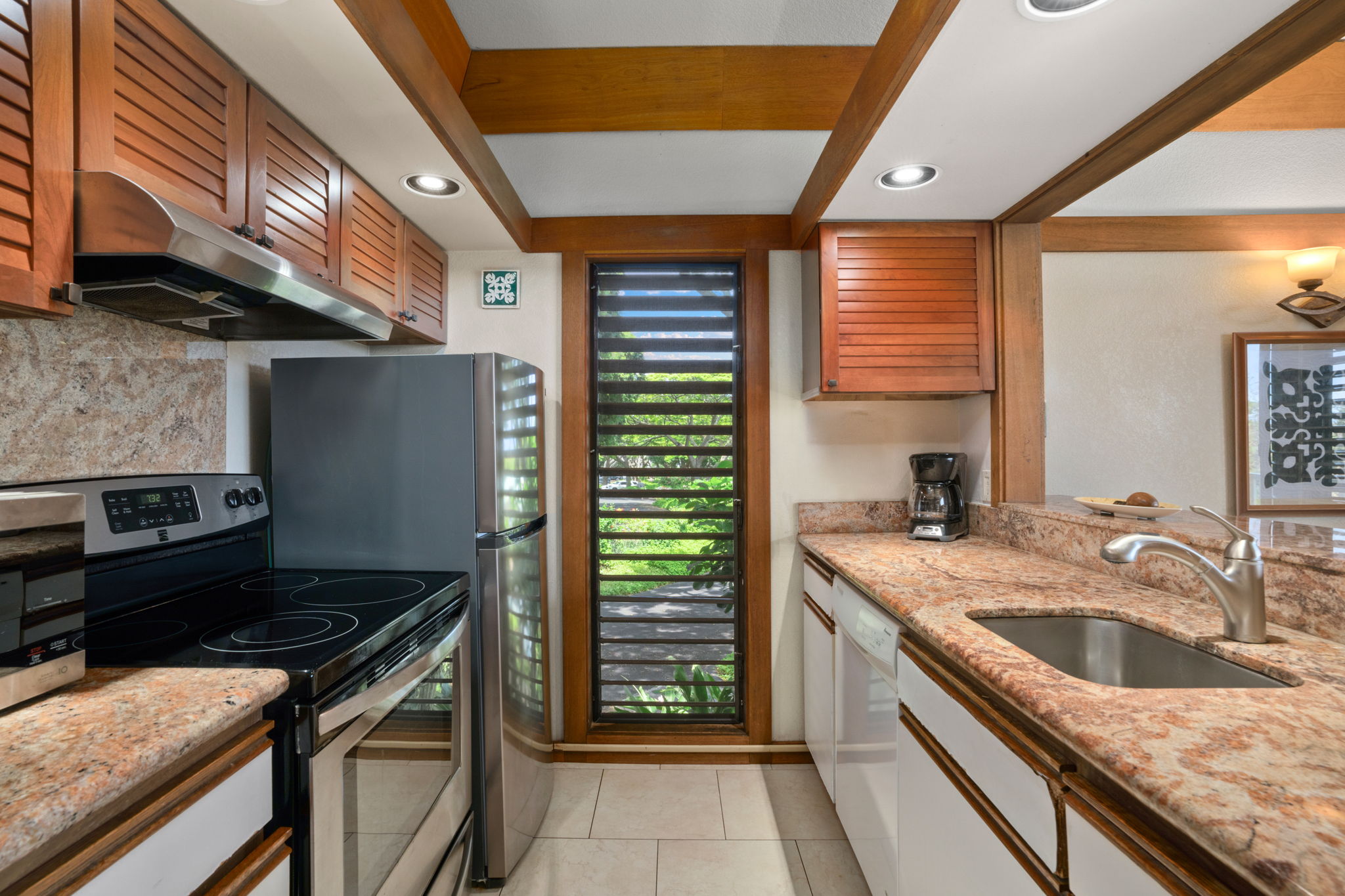 2253 Poipu Road, Unit 330 Koloa, HI 96756 - Photo 3 of 26 a kitchen with a sink stove and cabinets
