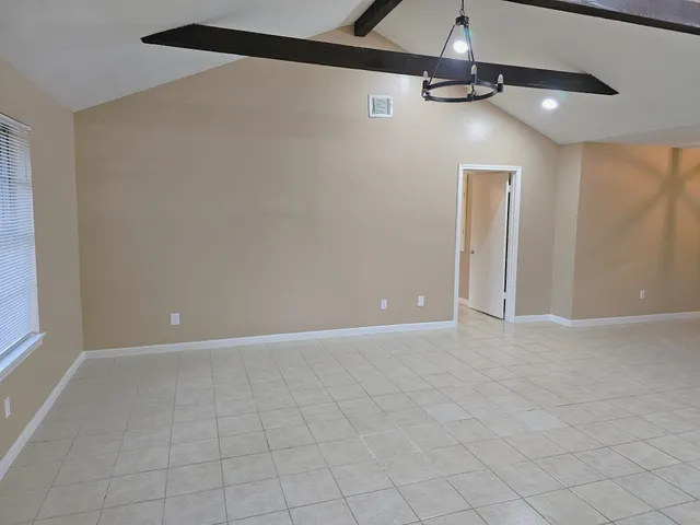 a view of an empty room with windows