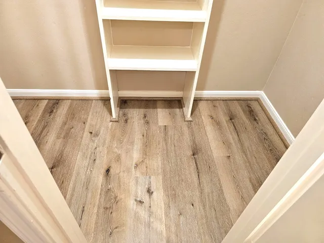 a view of room with wooden floor