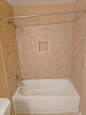 a bathroom with a shower and a toilet
