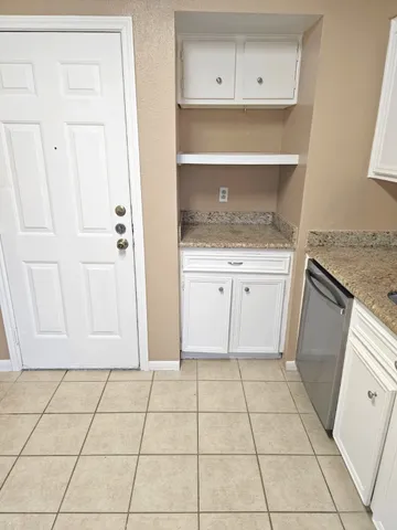 a kitchen with white cabinets