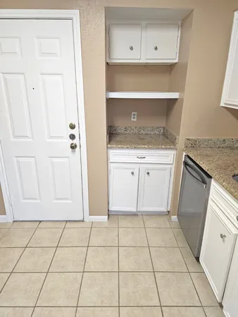 a kitchen with granite countertop white cabinets and a granite counter tops