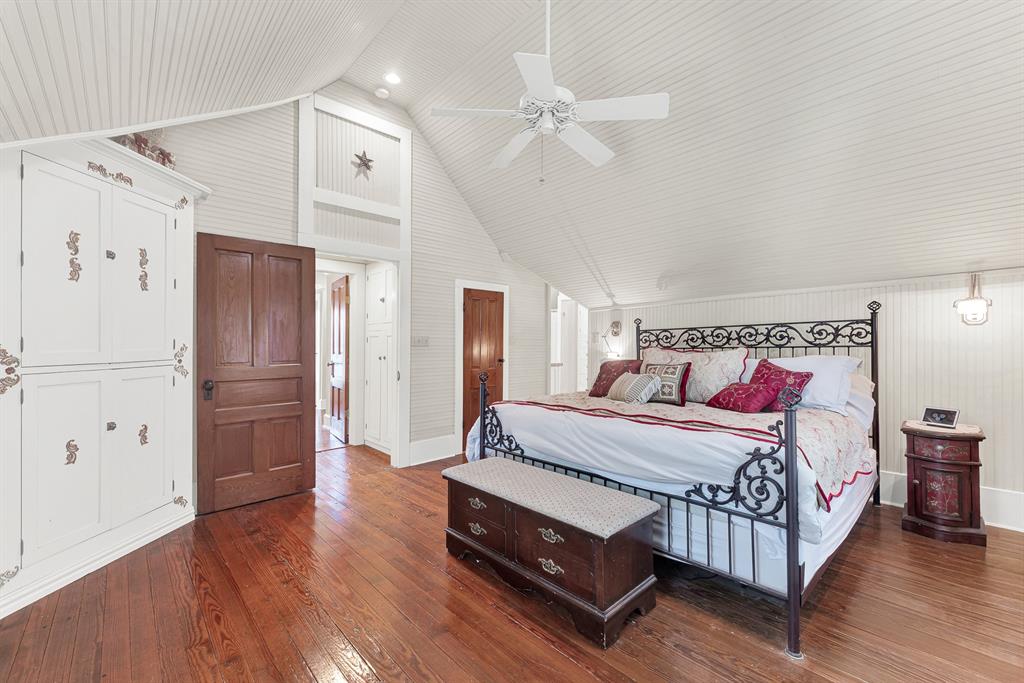 1425 Lone Star Road Celina, TX 75009 - Photo 13 of 40 Vaulted beadboard ceilings and beautifully restored original hardwood floors create an airy retreat that blends historic character with the comfort of a thoughtfully rebuilt home. Wake to peaceful country views and end each day in a space that feels quiet, bright, and wonderfully relaxing.