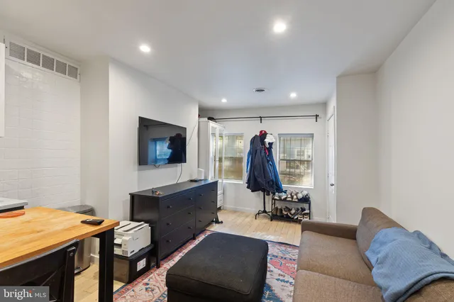 a view of a livingroom with furniture and a flat screen tv