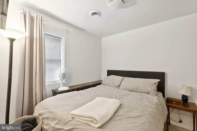 a bedroom with a bed and a window