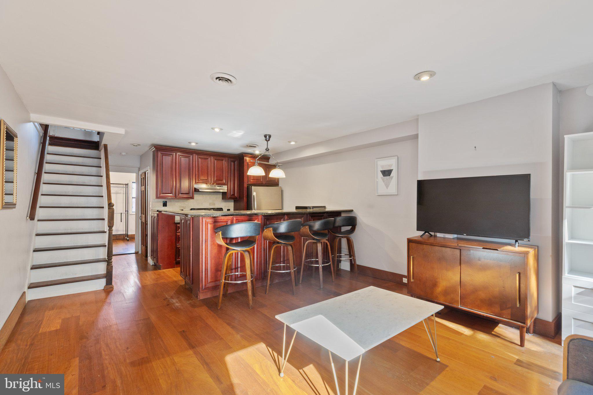 618 South 21st Street Philadelphia, PA 19146 - Photo 7 of 16 a living room with furniture a flat screen tv and kitchen view