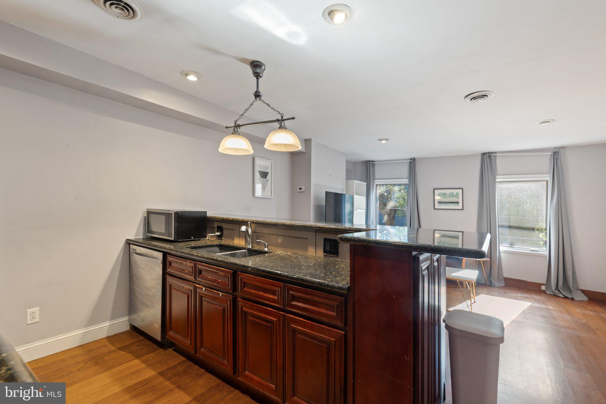 618 South 21st Street Philadelphia, PA 19146 - Photo 9 of 16 a kitchen with stainless steel appliances granite countertop a sink a stove and a wooden floors