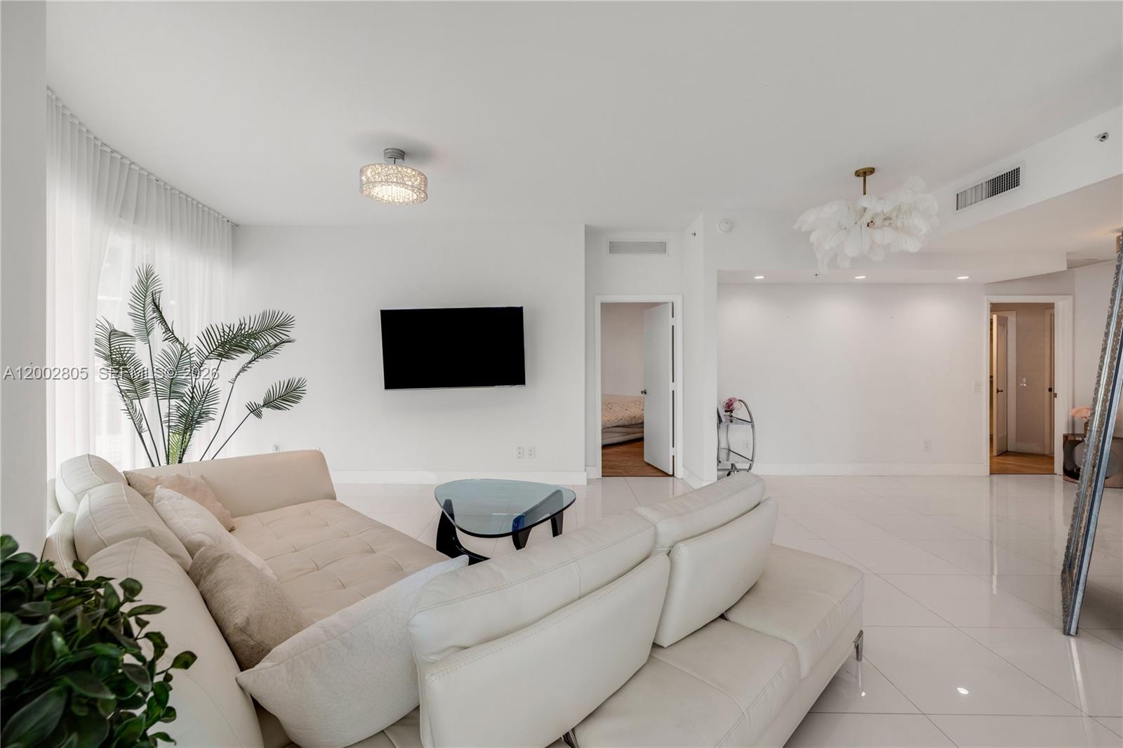 60 Southwest 13th Street, Unit 1124 Miami, FL 33130 - Photo 4 of 30 a living room with furniture and a flat screen tv