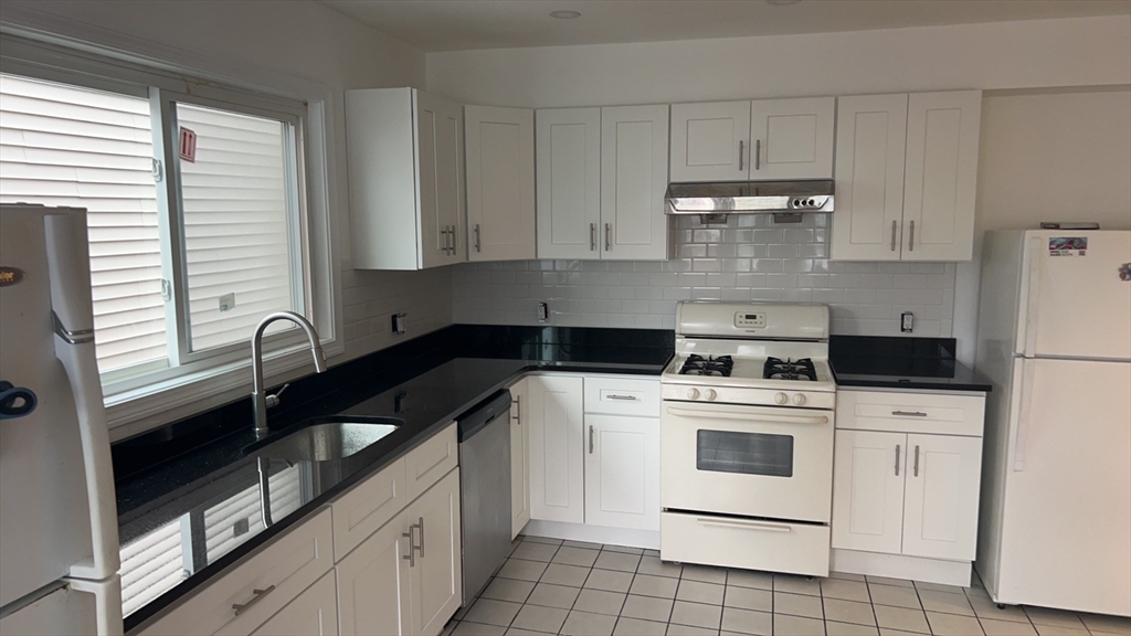 22 Marcella Street, Unit 2 Cambridge, MA 02141 - Photo 3 of 9 a kitchen with cabinets appliances and a sink
